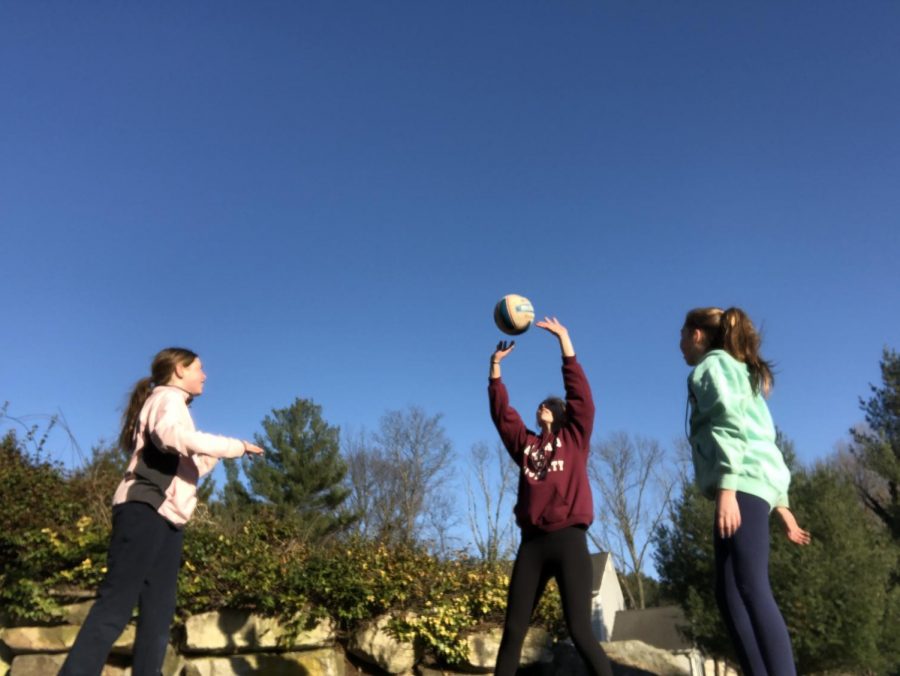 Freshman Shannon Clark and her sisters practice their voilleyball skills during quarantine.