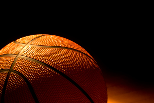 Close-up of a basketball left on the court