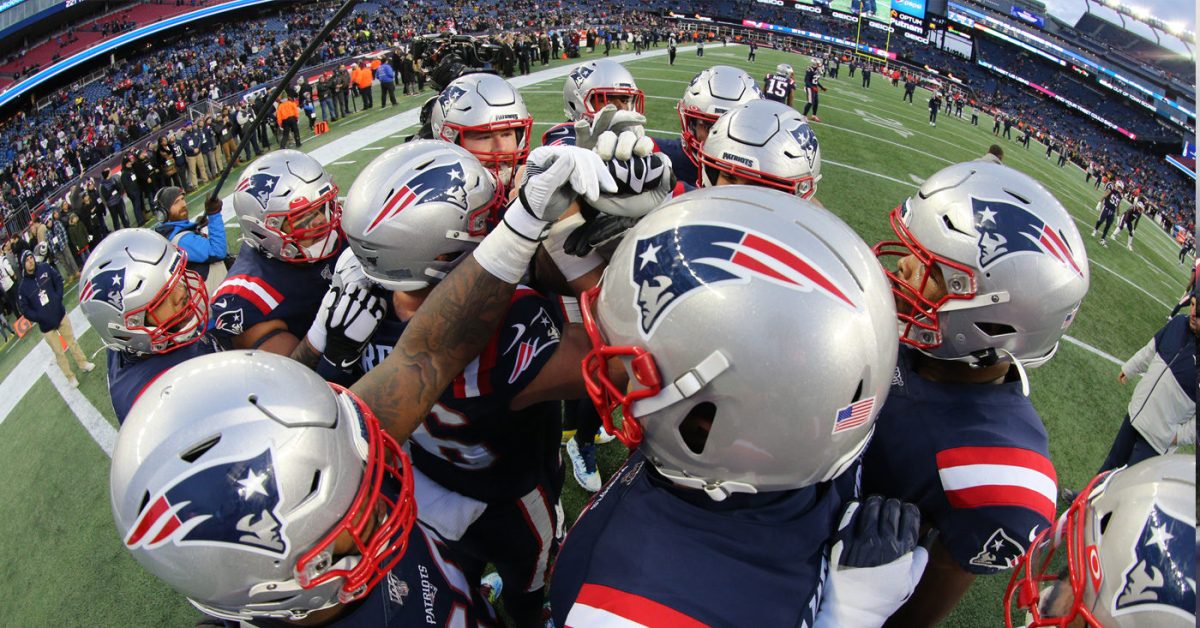 Patriots Photographer takes photo of well orchestrated Patriots huddle. 