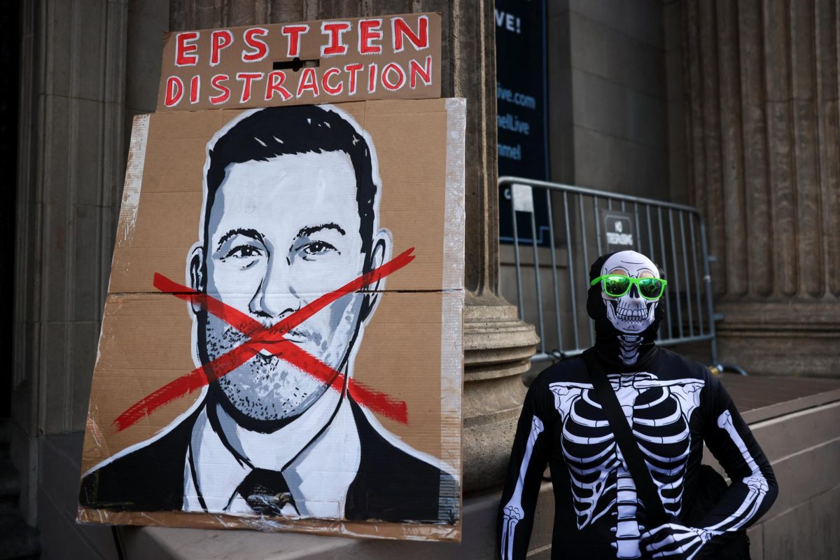 A demonstrator dressed in a skeleton suit stands next to a sign featuring Jimmy Kimmel, during a protest at the El Capitan Entertainment Centre, where "Jimmy Kimmel Live!" was recorded for broadcast, following his suspension for remarks he made regarding Charlie Kirk’s assassination, on Hollywood Boulevard in Los Angeles, California, U.S. September 18, 2025.  REUTERS/David Swanson