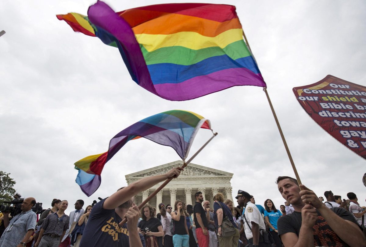 Supporters of gay marriage wave the rainbow flag after the U.S. Supreme Court ruled on Friday that the U.S. Constitution provides same-sex couples the right to marry at the Supreme Court in Washington June 26, 2015. REUTERS/Joshua Roberts