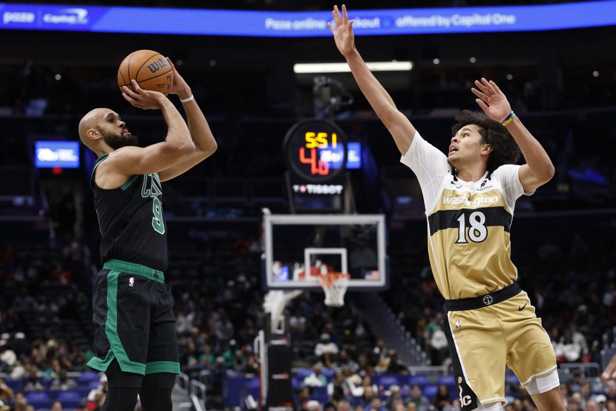 Dec 4, 2025; Washington, District of Columbia, USA; Boston Celtics guard Derrick White (9) shoots the ball as Washington Wizards forward Kyshawn George (18) defends in the first half at Capital One Arena. Mandatory Credit: Geoff Burke-Imagn Images